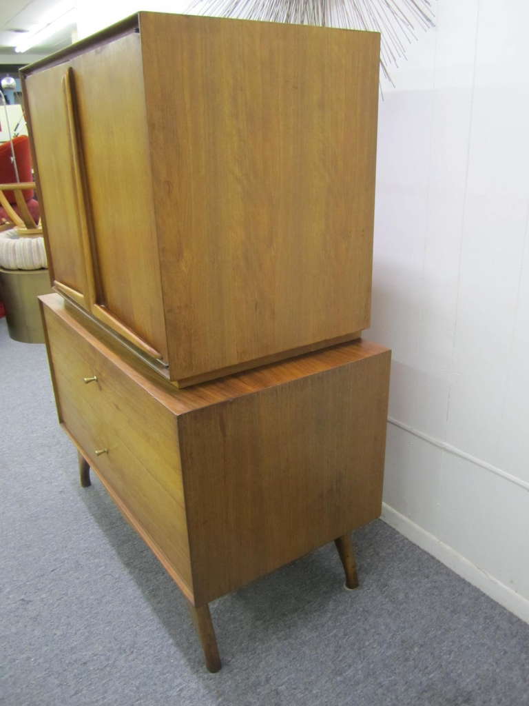 Wonderful sculptural walnut tall dresser.  Just look at the stylish splayed legs and well sculpted boomerang pulls.  Please see my other 1stdibs listing for other pieces from this fabulous vintage collection-credenza,night stands and headboard.