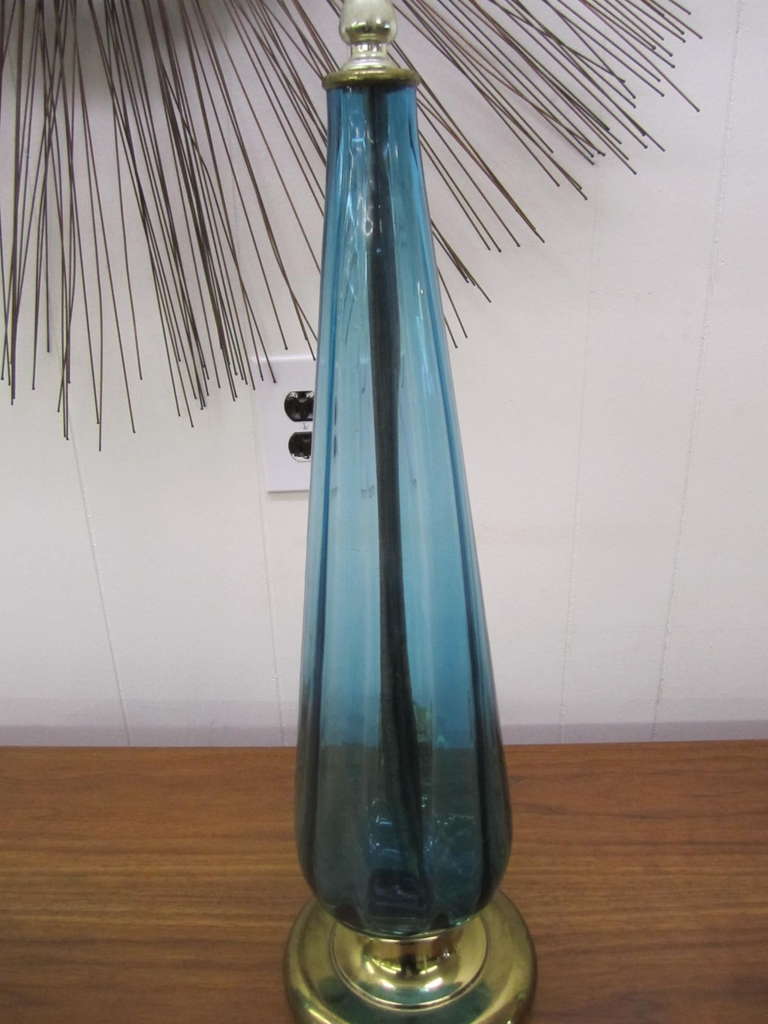 Stunning pair of turquoise Blenko style Murano glass lamps.  Beautiful slightly ribbed turquoise Murano blown glass.paired with solid brass bases.  The lovely drum shades are silk and are included with this sale.