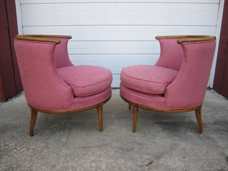 Lovely pair of hollywood regency barrel back lounge chairs.  Wonderful distressed wood details the edge of the barreled backs. I love the scale and style of this vintage pair
