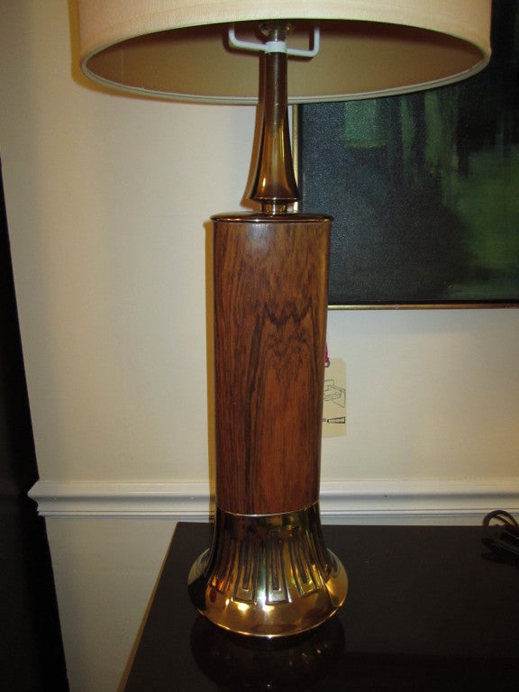  Handsome pair of tall rosewood veneer and brass Laurel lamps.  The graining on the bases is quite lovely and the brass has a nice vintage patina.