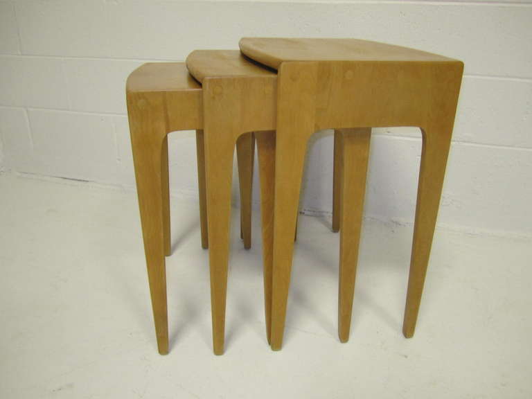 Lovely and rare set of three Heywood Wakefield solid maple nesting tables. I love the chunky thick sides with the thin front edge-very stylish. All the tables are in very nice condition.