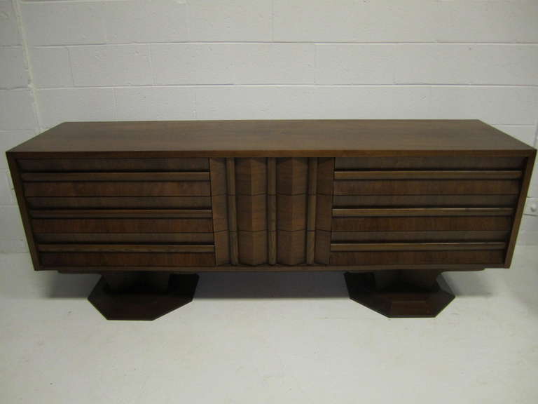 Fabulous brutalist style walnut credenza sitting on a double pedestal. Wow! is what you say when you see this magnificent piece in person. The stylish louvered walnut drawer fronts are super chunky and the well designed pedestals put this piece over