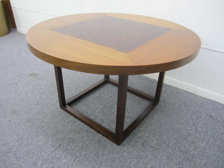 Very handsome circular walnut end table in the manner of Baker. Wonderful.