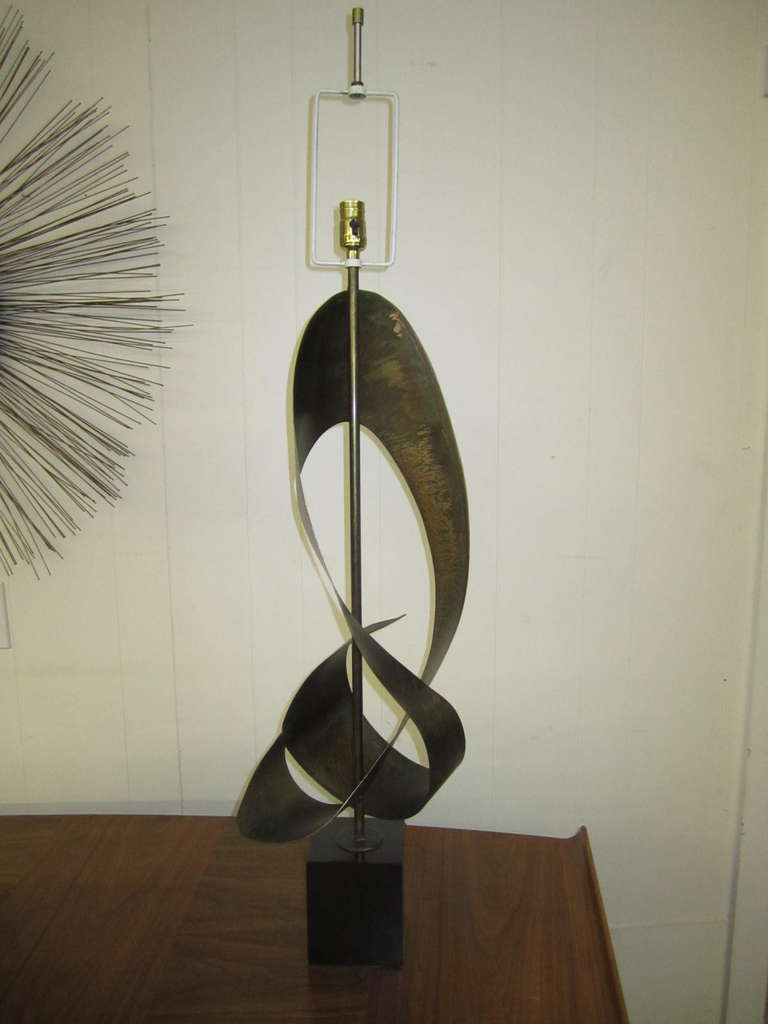 Huge Harry Balmer designed ribbon lamp made by Laurel Lamps.	Patinated steel dramatically sculpted into a abstract modern ribbon. Form and function-that the kind of art i love-you will too.