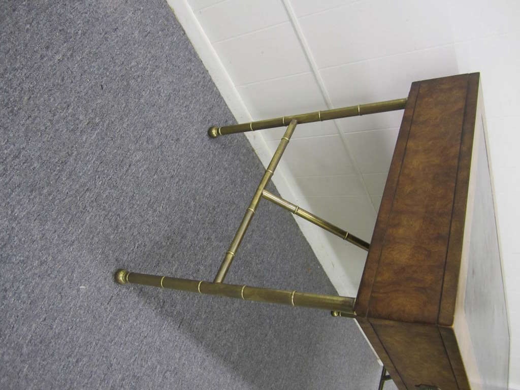 Gorgoeus John Widdicomb style burled walnut campaign desk with faux bamboo solid brass legs.  This desk came from a home loaded with high end Paul Mccobb and John Widdicomb pieces.  I do believe this to be a John Widdicomb piece but the label is