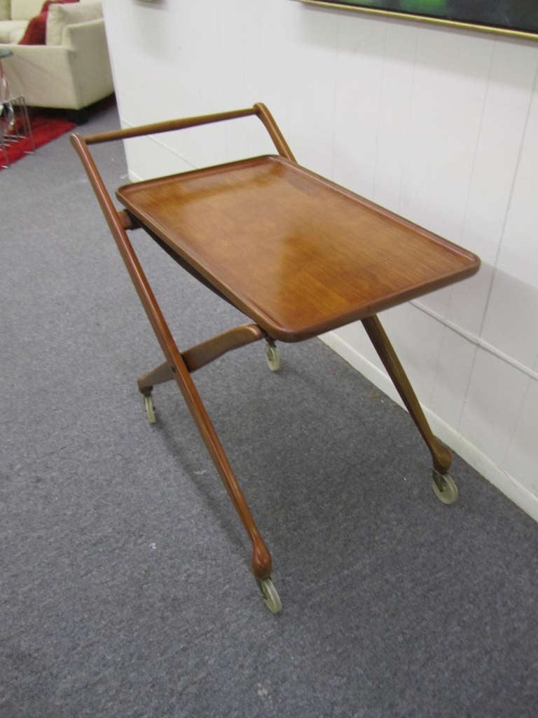 Wonderful folding rolling bar cart by Drexel, designed by John van Koert circa 1957. This piece is made of Italian walnut and retains its original finish.  I love the removable solid wood tray and collapsible frame for easy storage.  Wonderful