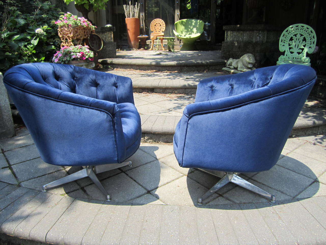 Simply scrumptious pair of swivel rocker club chairs in the style of Ward Bennett. These have brand new navy blue high end velvet upholstery and look amazing. The bases are polished aluminium and have a mellow aged patina. You will love everything
