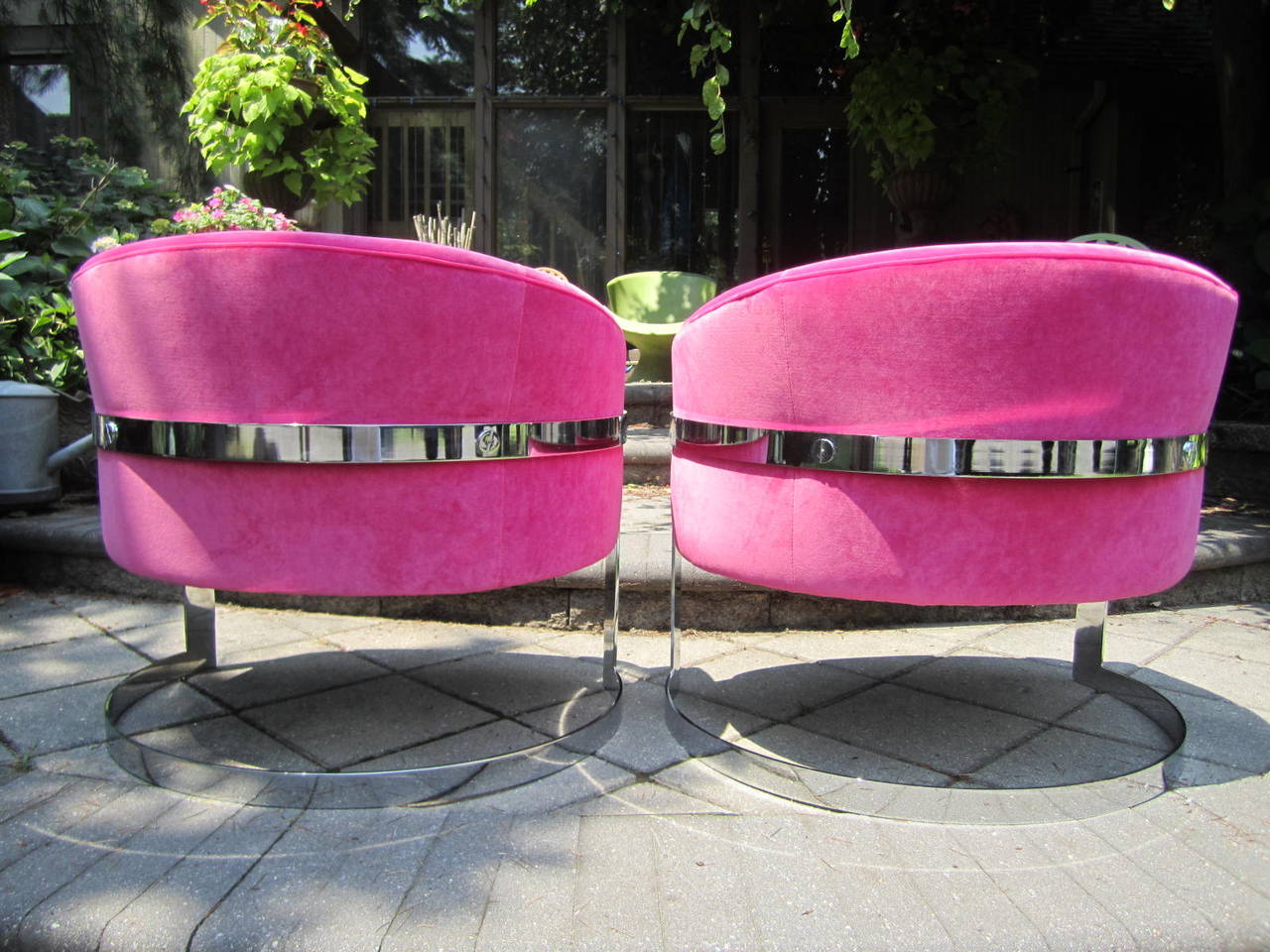 Excellent pair of Milo Baughman barrel back chrome cantilevered lounge chairs. This pair have been reupholstered in a fabulous hot pink high end velvet. They look absolutely amazing with mirror polished chrome and Barbie pink velvet. All of the