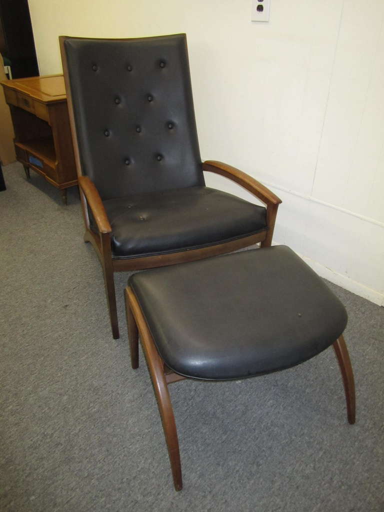 Very rare solid walnut chair and ottoman designed by Barney Flagg for Drexel.  Retains it's original black faux leather and is perfect for the designer who needs to reupholster.  Great lines with tremendous comfort!