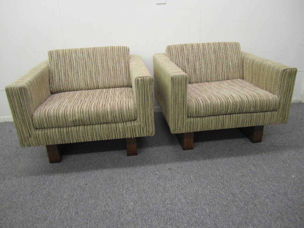 Outstanding and rare signed Harvey Probber pair of cube lounge chairs. This unusual pair rests on two chunky walnut legs that extend up the back-very handsome! These chairs retains their original nubby wool fabric in very nice condition. 