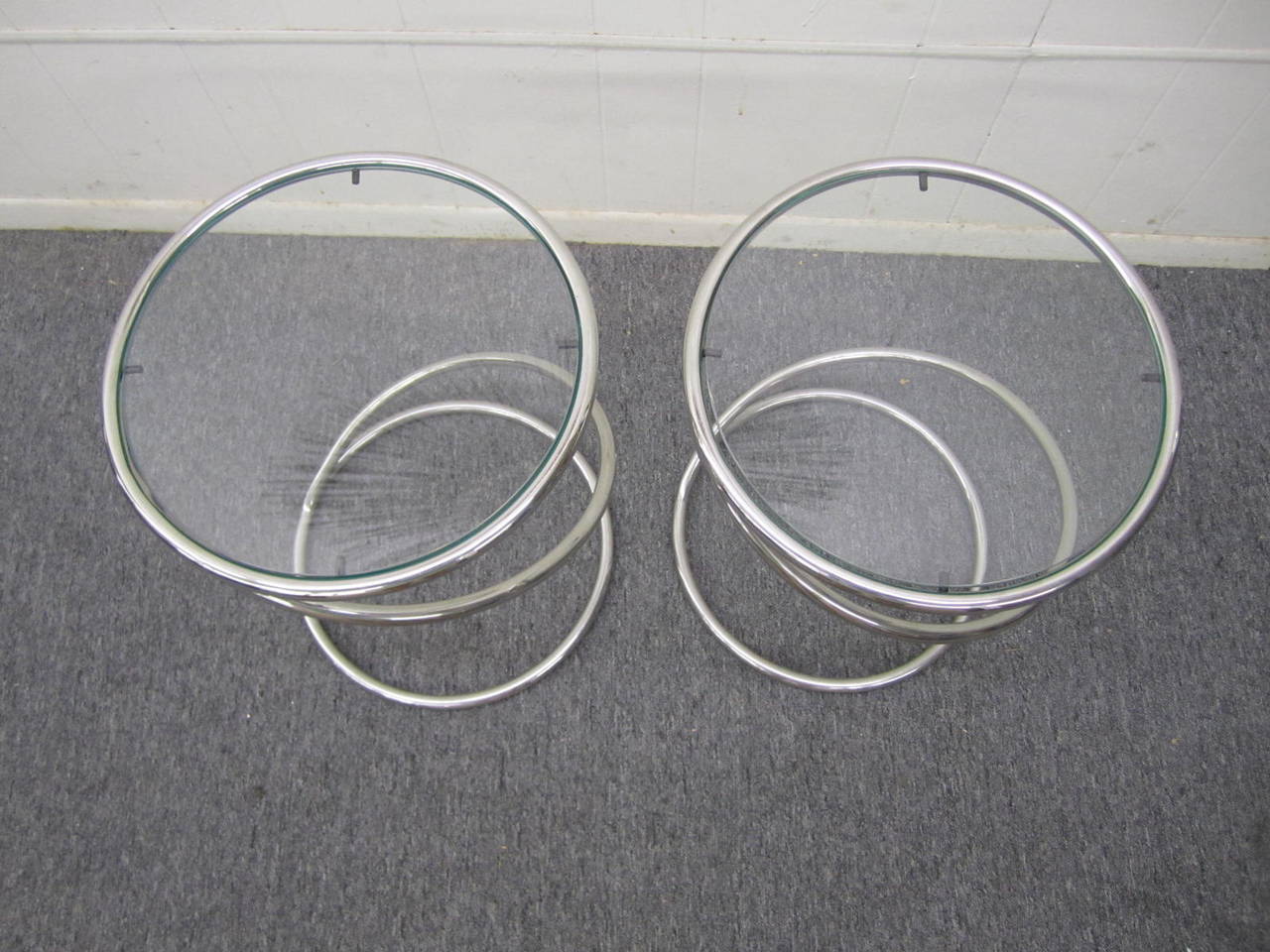 Sculptural pair of 1970s Pace Collection chrome spring tables. This pair of polished chrome and glass tables are called the 