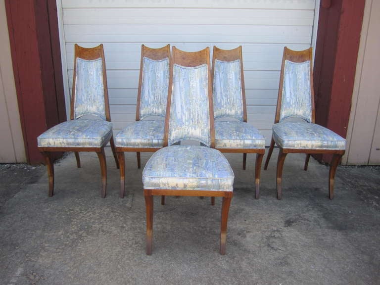 Outstanding set of 6 klismos leg burled wood dining chairs.  The upholstery is actually quite nice with a metallic detail running through it.  The chairs themselves are amazing in both shape and style. I know the photos show 5 but there are actually