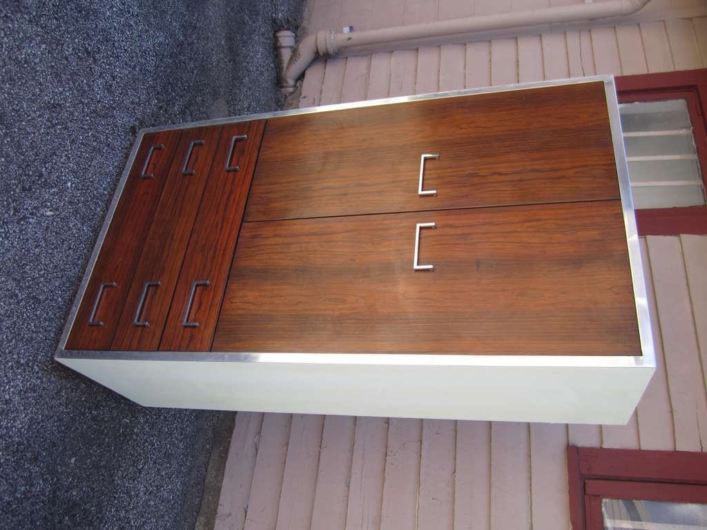 Handsome Milo Baughman style rosewood and chrome tall dresser.  The front of the piece is veneered rosewood with chrome accents and hardware.  The top and sides are lacquered white.  I do have the matching credenza and night stands listed in my