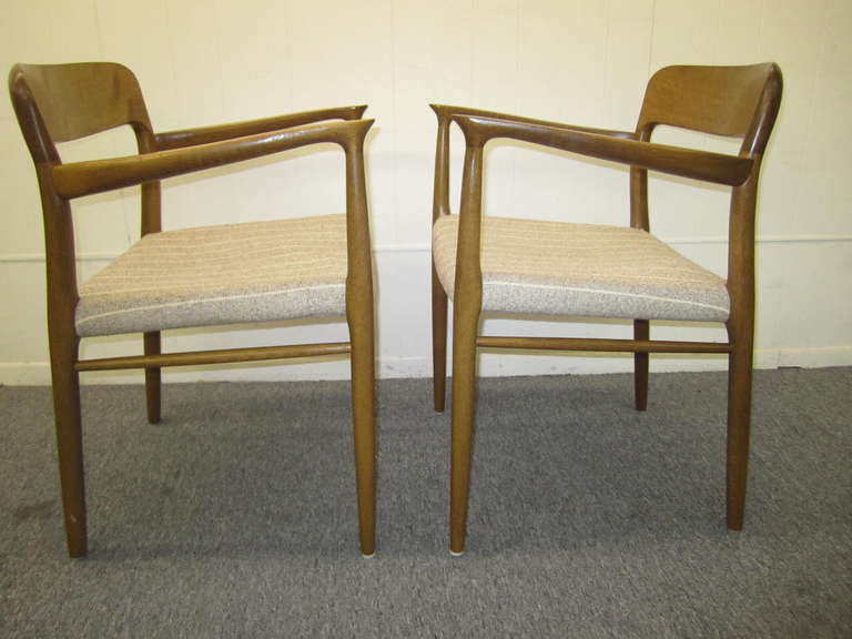 Wonderful set of J. L. Moller teak dining chairs. The chairs have a lovely honey brown vintage patina and look great. The seat pads will need to be reupholstered but that what you designer are looking for anyway-right? The solid teak frames are