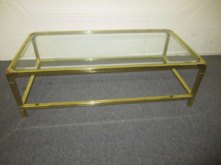 Brilliant solid brass Mastercraft coffee table. The brass has been newly polished and looks like a piece of fine jewelry. You will love the quality and craftsmanship of this Regency modern masterpiece. Please note that we also have the matching side