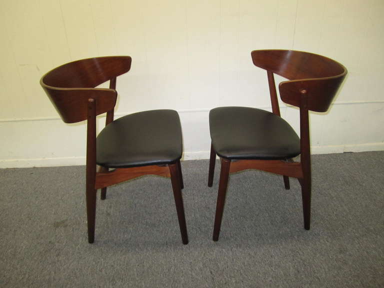 Excellent pair of Danish modern bentwood teak dining chairs.  Very stylish thick band of teak bentwood is used for the back with unusual angling of the back legs.  These chairs are very well constructed and engineered-definetely designed by a