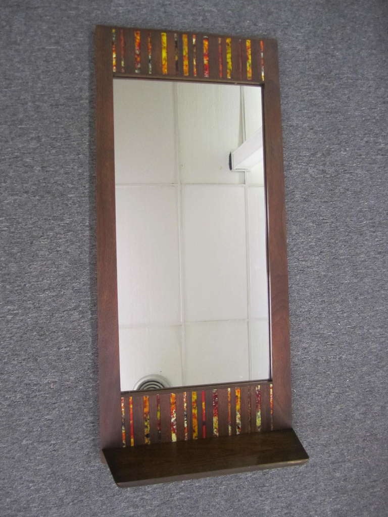 Unique and rare Harris Strong tile mirror with built in shelf.  Honestly, i have never seen another mirror made by Harris Strong.  I have seen the lamps and the tile plaques but the mirrors are very rare.  This one has vibrant textured orange strips
