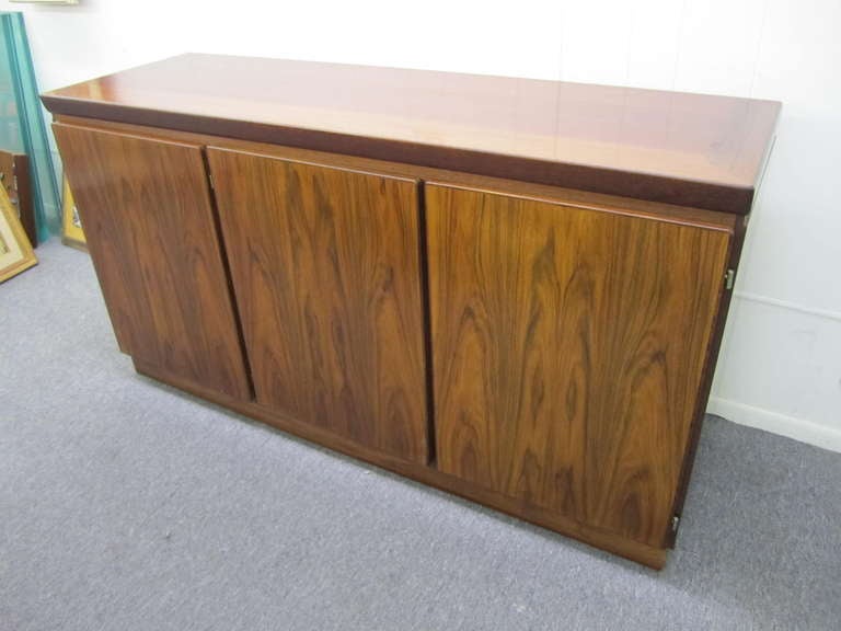 Gorgeous danish modern Rosewood china cabinet credenza.  Amazing deep dark Brazilian rosewood with tons of storage this piece has it all.  The handsome light up removable top has three glass doors and plenty of adjustable glass shelves to store all
