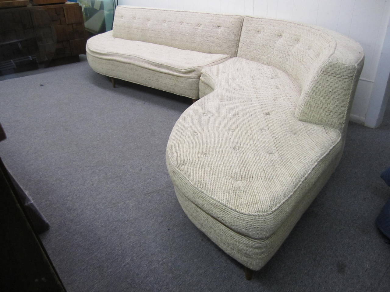 Great looking two-piece serpentine sofa. This piece does need upholstery- perfect for you designer who need to upholster in your clients favorite fabric. We do offer an upholstery service if needed. This sofa measures at it's longest 135