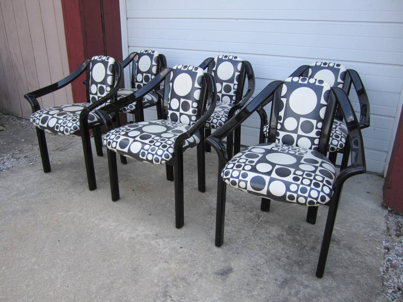 Fantastic fun set of six Panton style black lacquer dining chairs. The upholstery is in gorgeous condition being a vinyl covered Panton design. The black lacquered frames only show light wear and are quite usable as is. This set is extremely