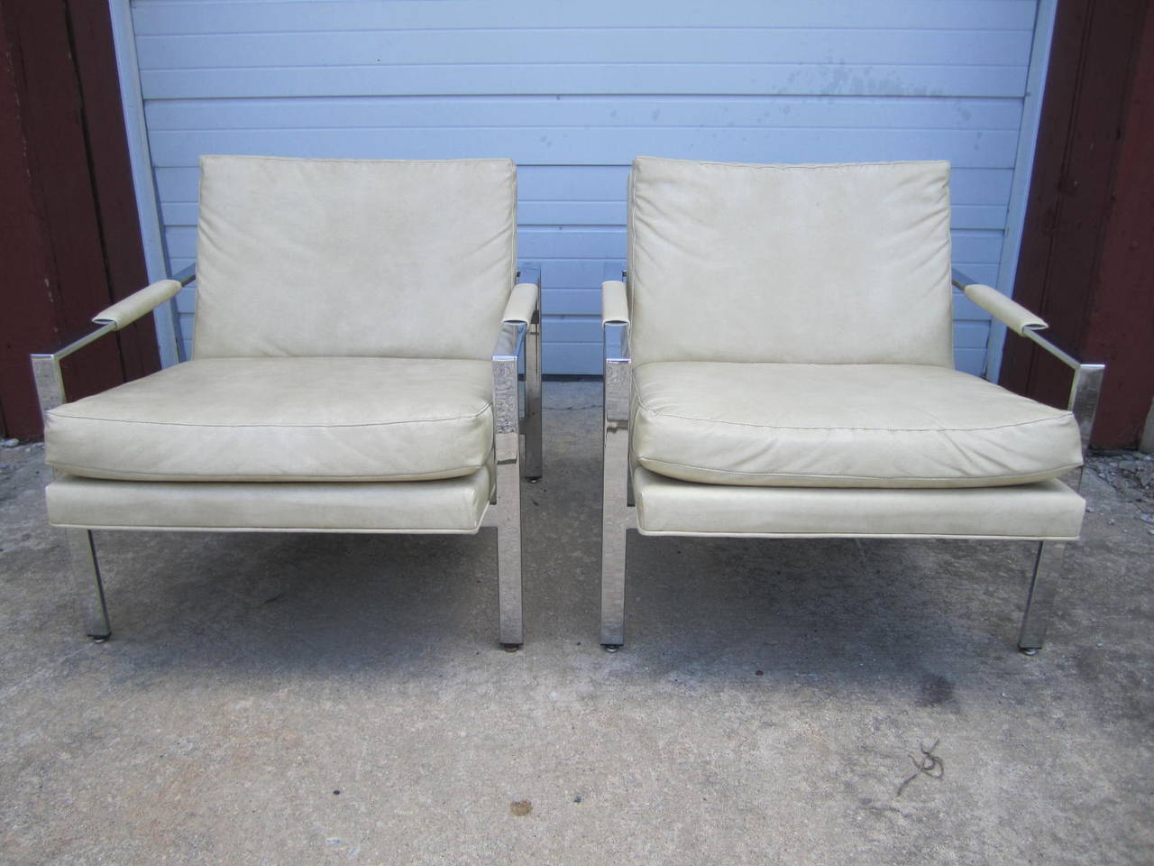 Fabulous pair of Milo Baughman Thayer Coggin chrome flat bar cube chairs. Upholstery is a cream colored faux leather in presentable condition. Would be even better reupholstered in something fresh. We do offer an upholstery service if needed. The