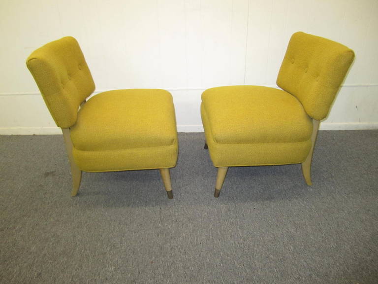 A pair of slipper chairs in the style of American decorator Billy Haines. The lovely legs of the chairs are painted with brass sabots on the tapered front legs. The chairs are low and comfortable, with generously proportioned seats. The original