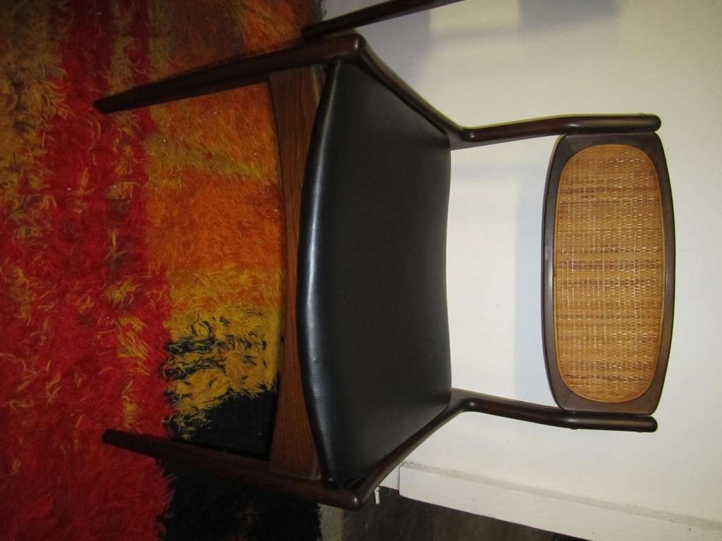 Set of 6 danish modern signed Selig walnut caned back dining chairs.  This set retains their original finish and the backs have been re-caned recently.  The seat pads are upholstered in faux  black leather and look great.  This set includes 2 arm