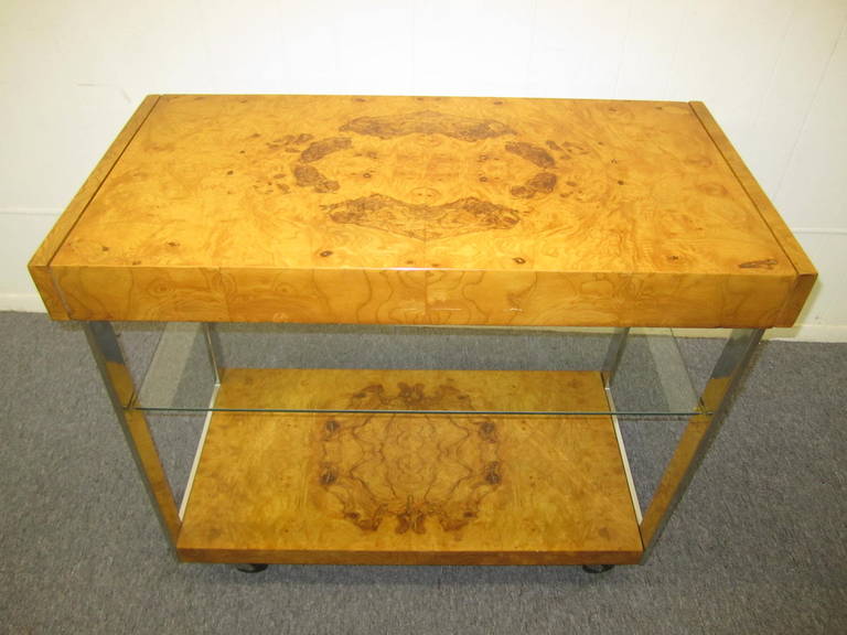 Extremely rare Milo Baughman burled olivewood bar trolley on wheels with a center glass shelf.  This is the 1st one of these we have have ever seen and we love it!  Wonderful extending formica shelves pull out from either end.  This piece is in