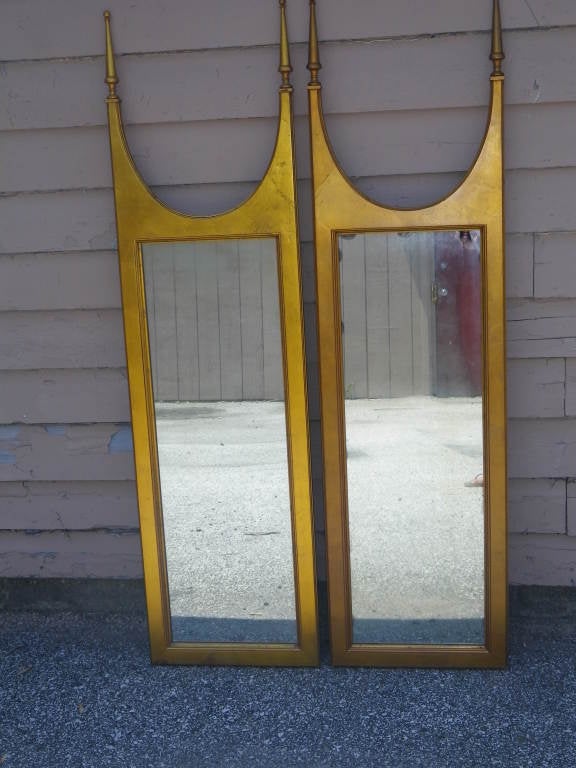 Lovely pair of hollywood regency modern gilded gold designer mirrors.  Fantastic proportions and fabulous vintage patina make these mirrors a rare find.