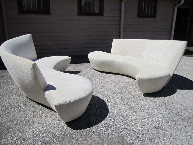 Gorgeous pair of sculptural modern sofas. These sofas are breathtaking in person-sure to make a huge statement. Please note that these sofas are exactly the same-not bookmatched-see 2nd and 3rd photos. The high part of the back is on the right on