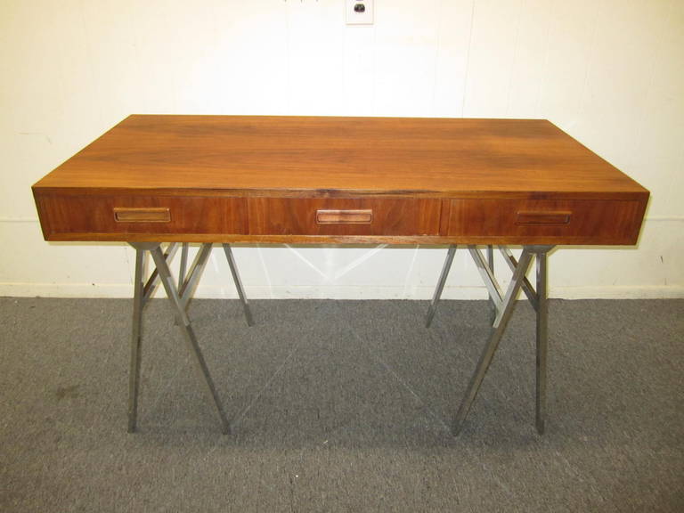 Gorgeous Milo Baughman walnut and chrome saw horse desk. The top is in fantastic shape with little to no wear. The chromed steel saw horse legs are very sturdy and look great with the warm walnut top. This piece is finished on all sides and can be