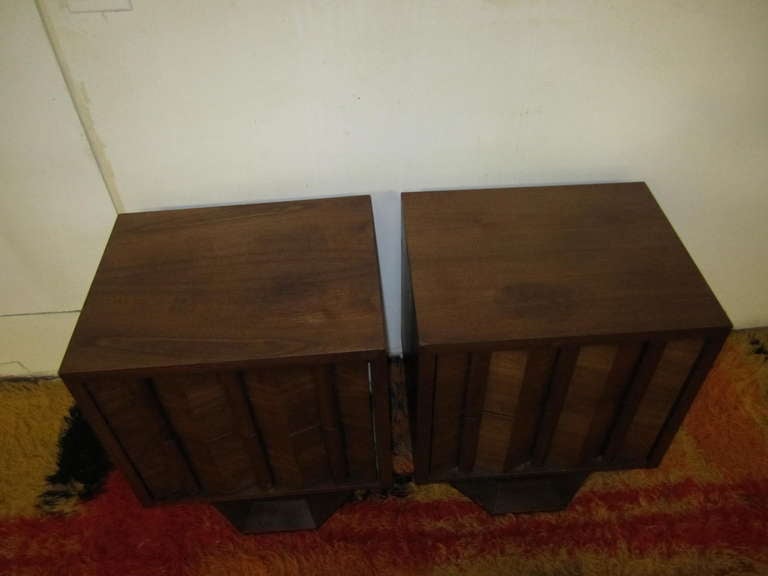 Unusual  pair of brutalist style walnut night stands with gorgeous pedestal bases.  I love the sculptural chunky pleated drawer fronts and the architectural pedestals.