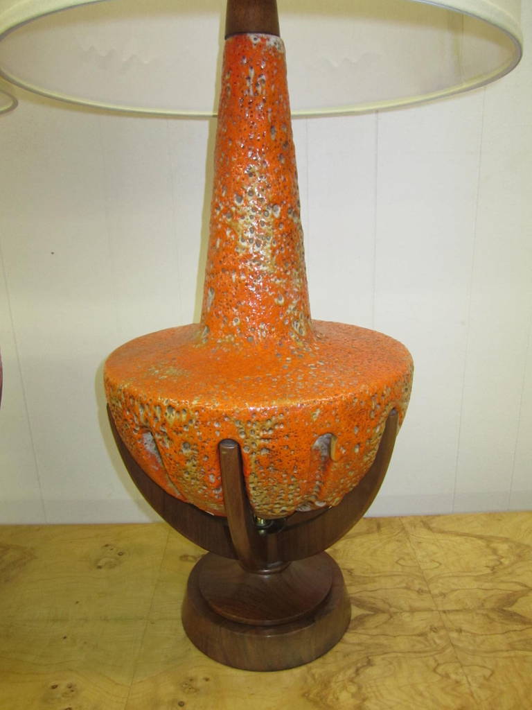 Amazing pair of thick lava glazed ceramic lamps with gorgeous walnut finger bases. These lamps are very rare and hard to come by in this condition or any condition. They are just fabulous in person and quite large measuring over 30