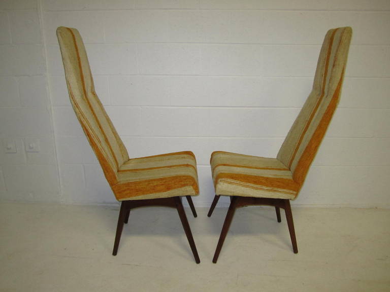 A set of four vintage Mid-Century Modern high back dining chairs by Adrian Pearsall for Craft Associates. Chairs feature lovely sculptural seats over solid walnut bases and original, yellow striped upholstery. These interesting chairs would look