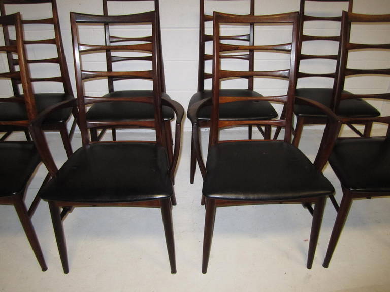 Outstanding set of eight solid rosewood Koefoeds Hornslet dining chairs. Fabulous deep dark rosewood richly grained with original faux black leather seats. The chairs are tight and sturdy-well cared for over 50 years. This amazing set was owned by