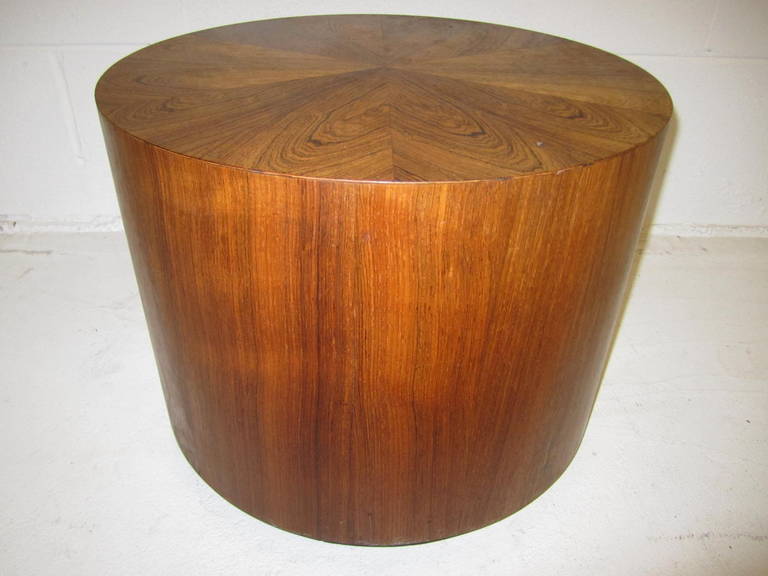 Lovely Danish modern rosewood cylinder table.  Wonderful top graining in a  flower motif.  I love the small rollers on the bottom enabling it to scoot around.  I have two of these available as seen in the last photo.  This offering is for the