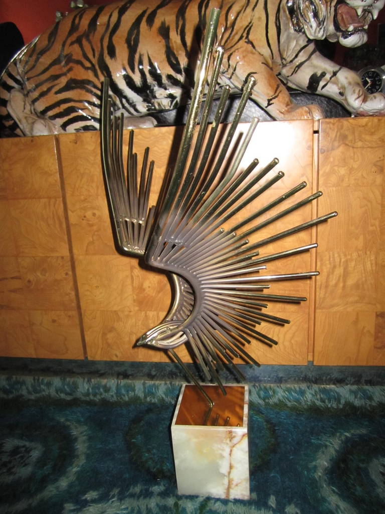 Table sculpture attributed to Curtis Jere. Heavy metal rods make up an eagle in flight posted in a solid marble base.

Curtis Jere is a compound nom-de-plume of artists Curtis Freiler and Jerry Fels. The two founders combined pieces of their own