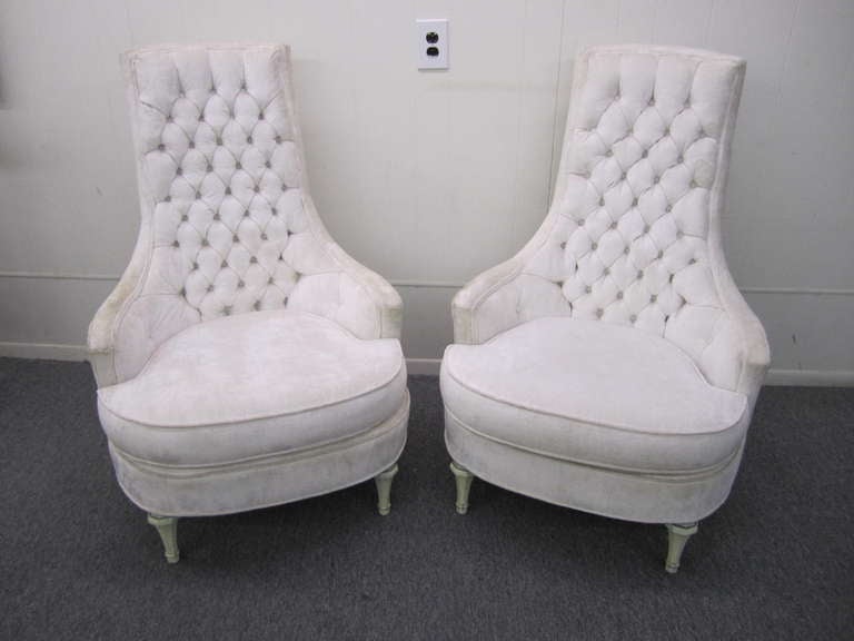 Gorgeous pair of hollywood regency high back tufted chairs.  Super glamorous with their low wide seats and tall tufted backs.  The retain their original white crushed velvet upholstery in nice vintage condition.