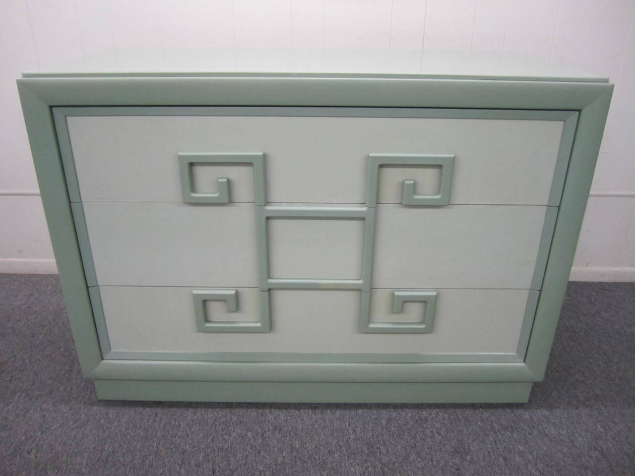 Fabulous chest of drawers or dresser by Kittinger from their earliest Mandarin collection with bold Greek key drawer handles. Retains its original two-toned light green lacquer finish in very nice vintage condition. Original Kittinger paper label in