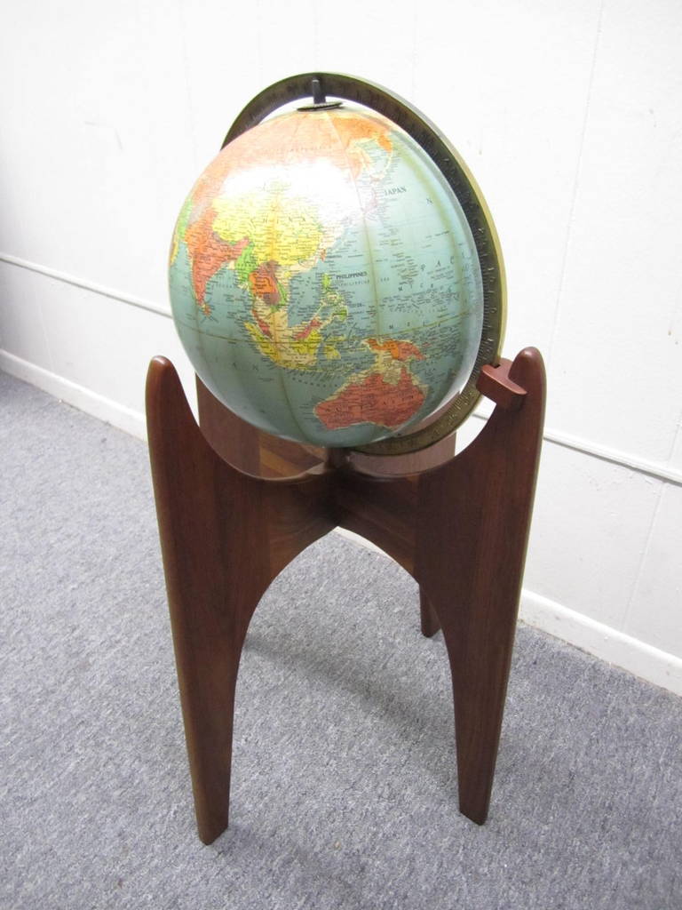 Handsome Adrian Pearsall solid walnut world globe.  This Replogle globe from the 1960s rests in a beautifully crafted walnut stand by renown American designer Adrian Pearsall (1925-2011). 2 years after receiving a degree in architectural