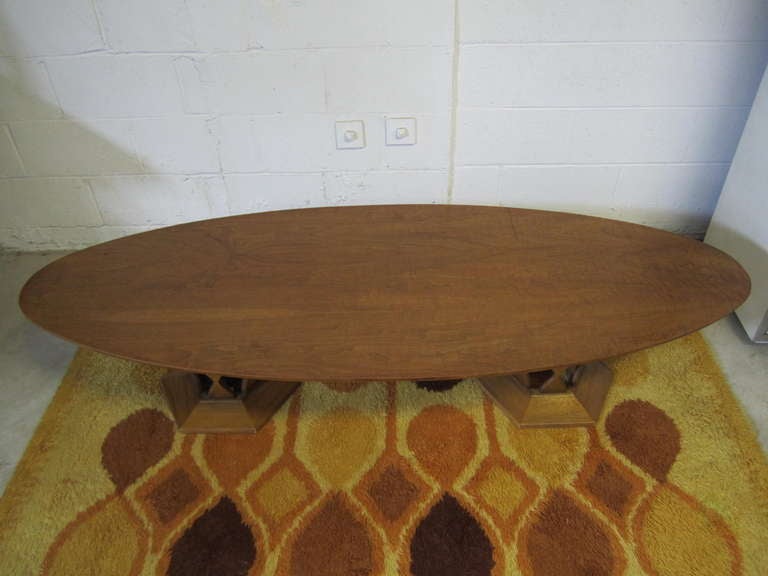 Unusual large surfboard top double pedestal coffee table.  You will love the warm walnut top with the sculptural double pedestal bases.