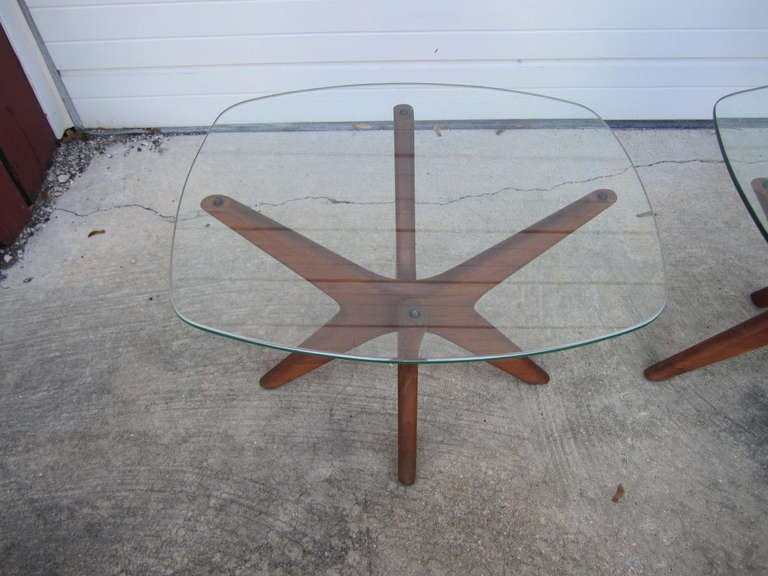 A pair of walnut and glass Pearsall side tables known to the profession as the 