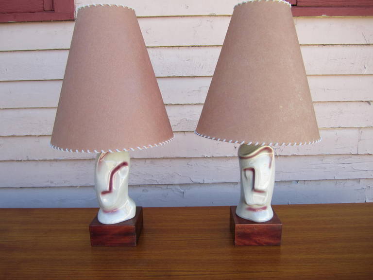 A Pair of 1950's Sculptural Ceramic Table Lamps signed Heifetz.  Wonderful Art Deco stylized Male and Female Head Lamps.   These unusual lamps measure 27