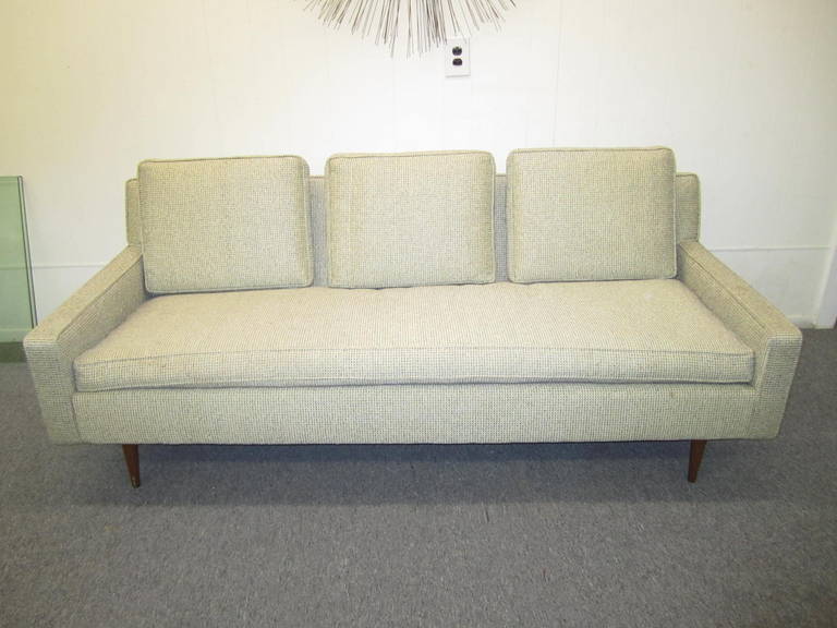 A very versatile pair of little sofa with conical legs attributed to Paul McCobb. These pieces are quite comfortable and have light proportions.