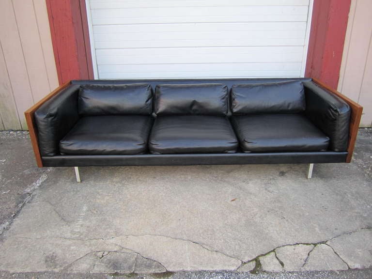 Stunning Milo Baughman walnut sofa with original faux black leather.  Sexy and sleek this sofa will surely be the center piece of any room.  Notice how the back is faux leather and not wood-looks really cool.
