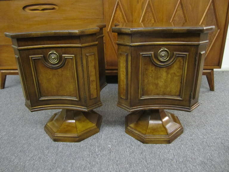 Unusual pair of Mastercraft walnut pedestal end table night stands.  Lovely petite stands finished on all sides with one well crafted door.  The tops have nice burled details around the edges along with a very unusual shape.  You will love the fun
