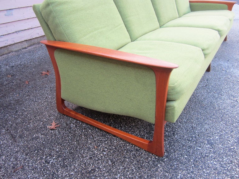 FABULOUS DANISH MODERN SOLID TEAK SCULPTURAL GRETA JALK 4 SEATER SOFA.  THE ORIGINAL VINTAGE LIME GREEN FABRIC IS GORGEOUS WITH VERY LITTLE WEAR.  THE SINUOUS CURVED SOLID TEAK LEGS ARE TIGHT AND STURDY AND ARE IN GREAT SHAPE.  THE ORIGINAL OWNER