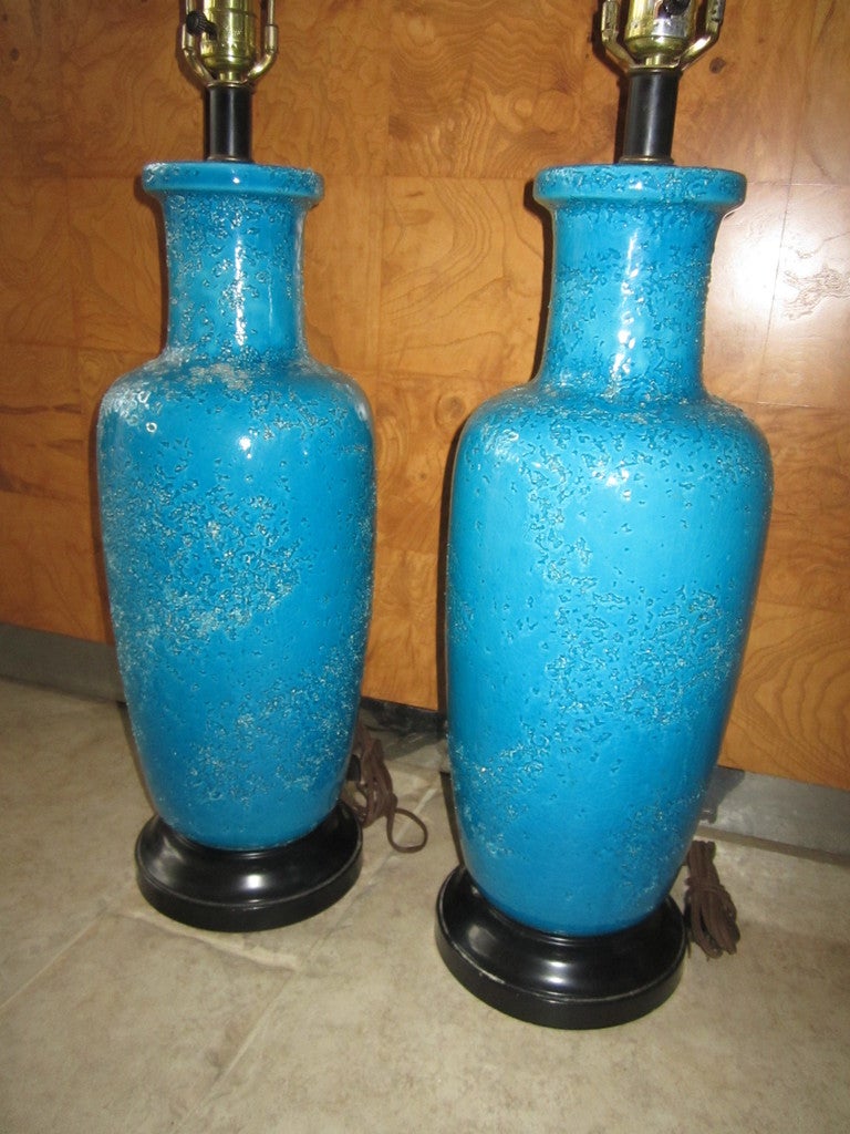 Lovely pair of blue Bitossi turquoise lava crackle lamps.  The glaze is fabulous on these vibrant blue lamps.  They are sure to make a huge statement in any decor-these lamps are in wonderful vintage condition.  I love the crackle glaze with the