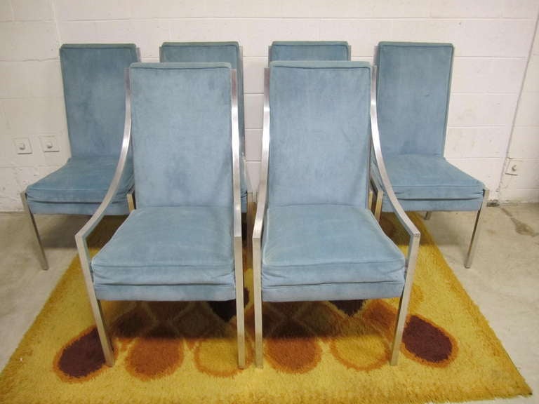 Wonderful set of super heavy solid aluminum dining chairs.  This set consist of 2 arm chairs with gorgeous swooped arms and extra wide angled seats.  You will be amazed at how heavy aluminum can really be when it is solid instead of tubular.  The