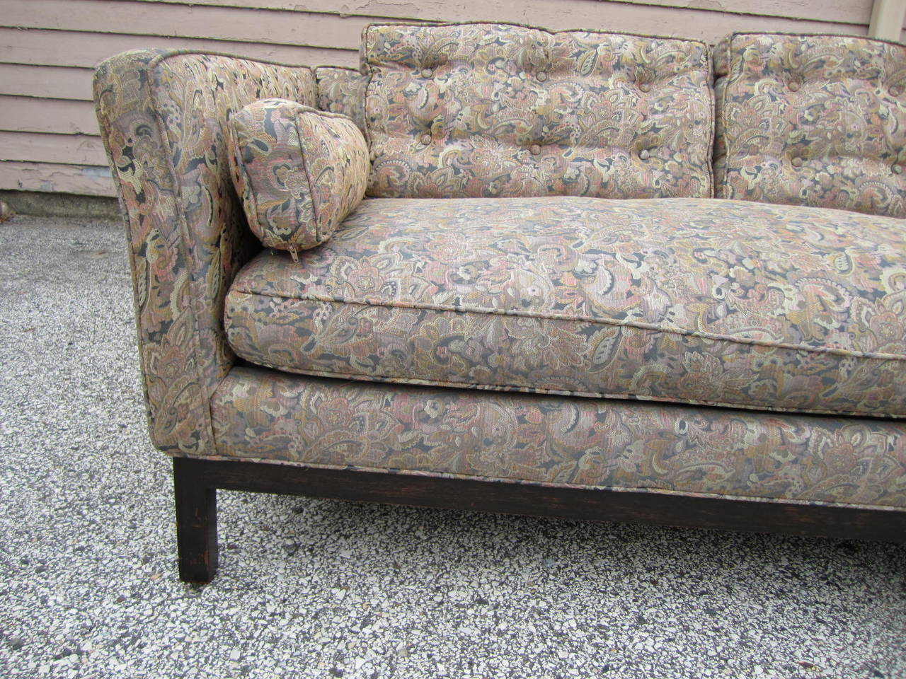 Stylish Harvey Probber style mid-century modern sofa.  Handsome dark walnut base with slightly flared boxy arms and straight back-very mid-century.  The fabric is an interesting paisley and still in good condition but reupholstery is recommended.